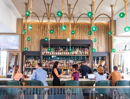 Two women drinking cocktails at the bar