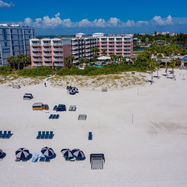 aerial of the beach with groups of beach chairs laid out