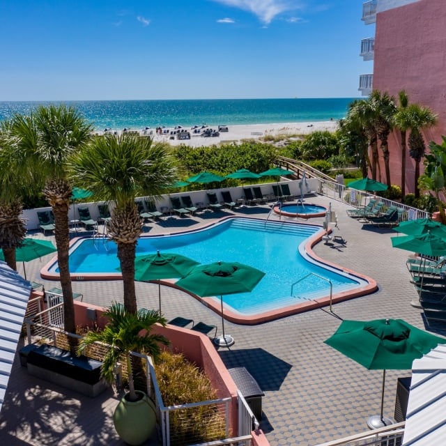 pool area with lounge chairs and a view of the ocean