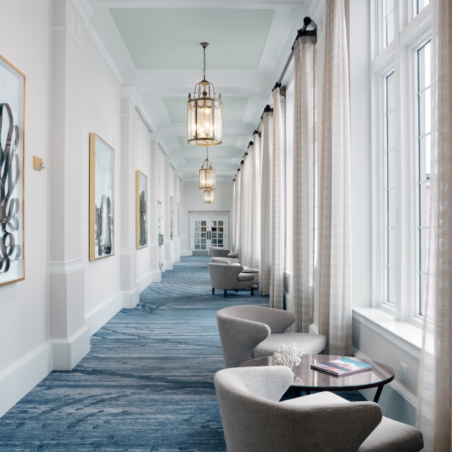 hallway with several small seating areas