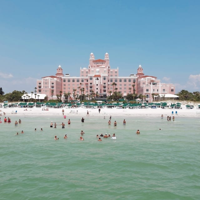 People in the ocean in front of The Don CeSar