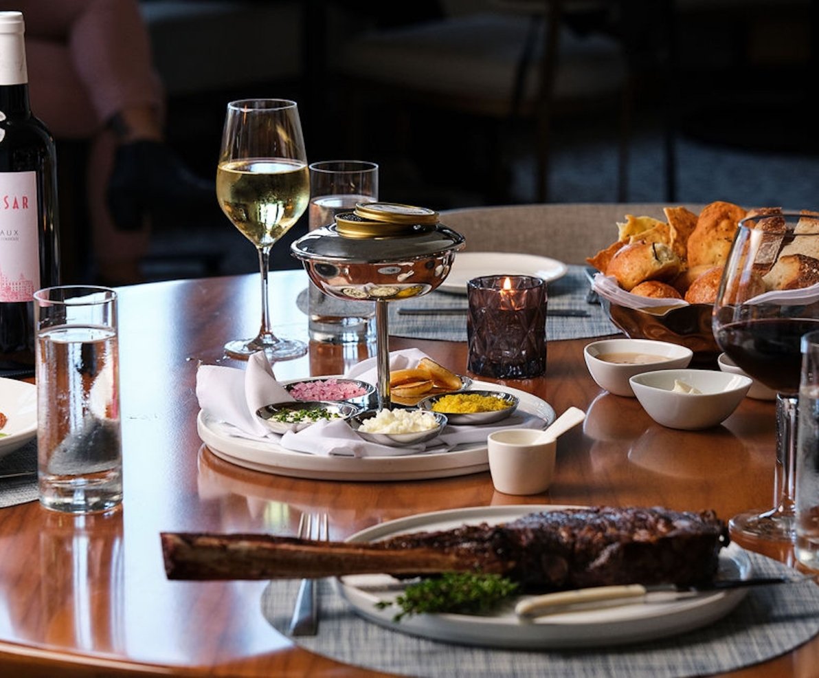 steak and wine on a wooden table