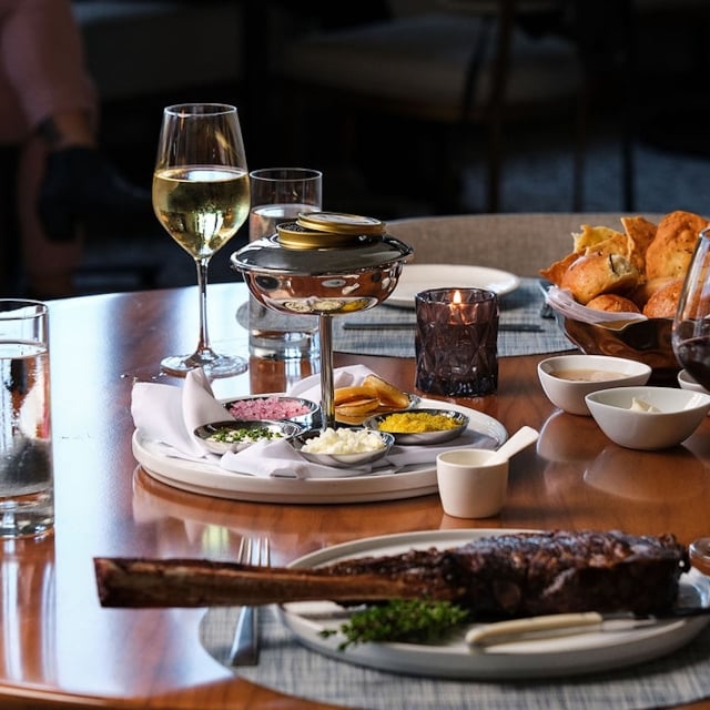 steak and wine on a wooden table