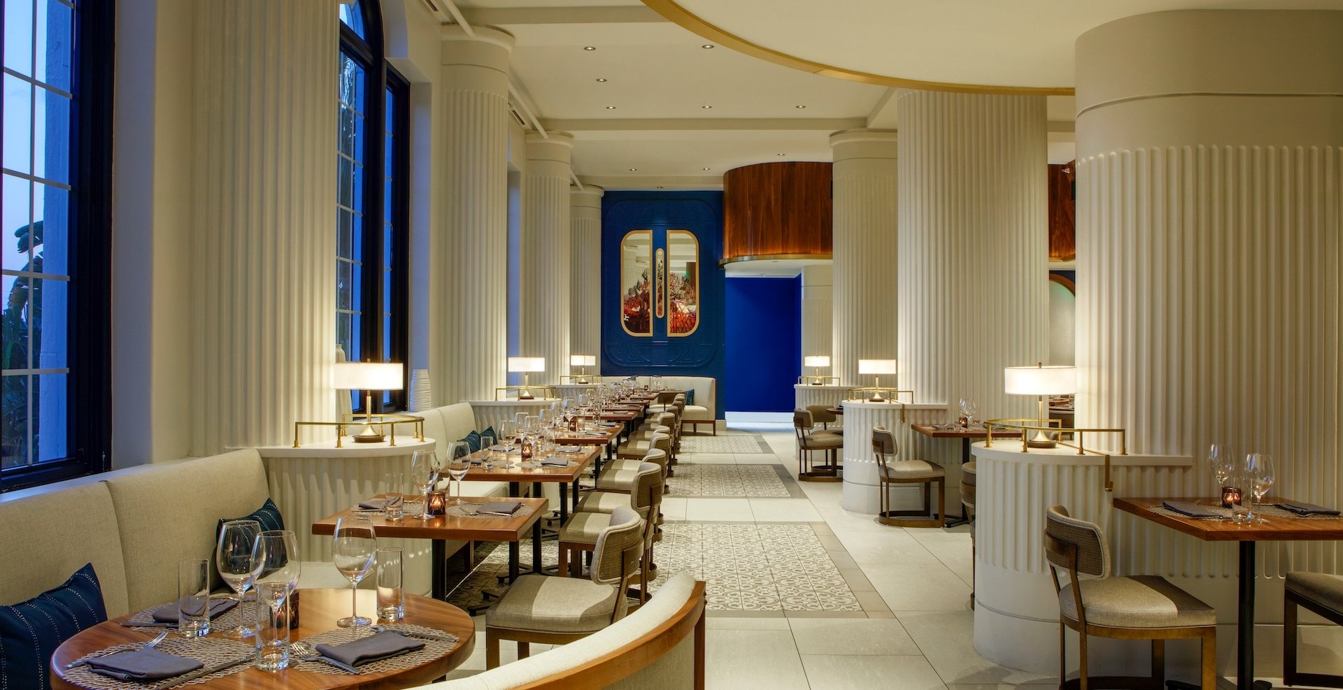 dining room with large white columns and blue walls