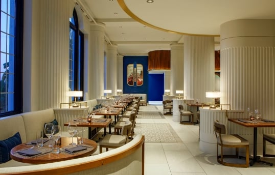 dining room with large white columns and blue walls