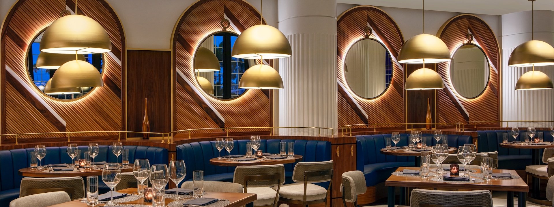 dining area with blue booths and wooden walls