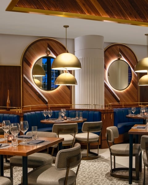 dining area with blue booths and wooden walls