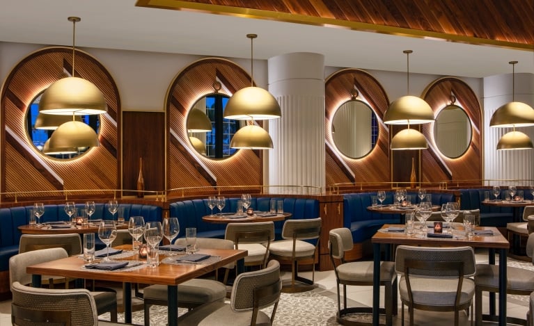 dining area with blue booths and wooden walls