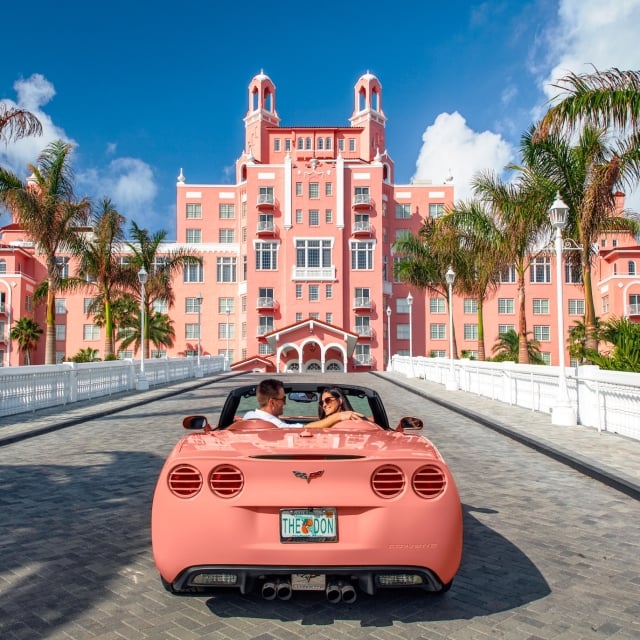 a couple heading to The Don CeSar in a pink convertable