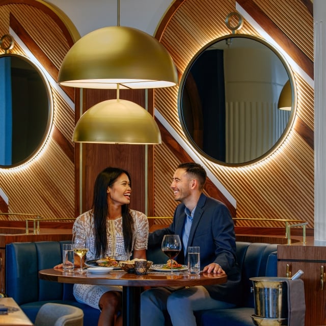 a couple eating dinner in a booth