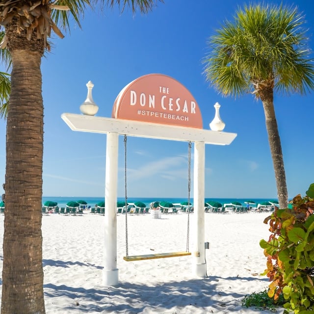 Swing with Don CeSar signage on the beach