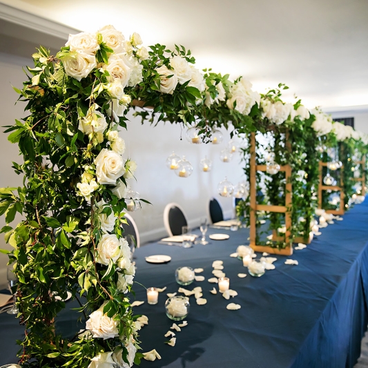 Long table with large floral arches