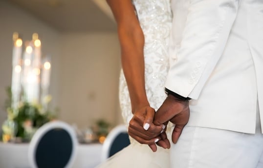 a bride and groom holding hands