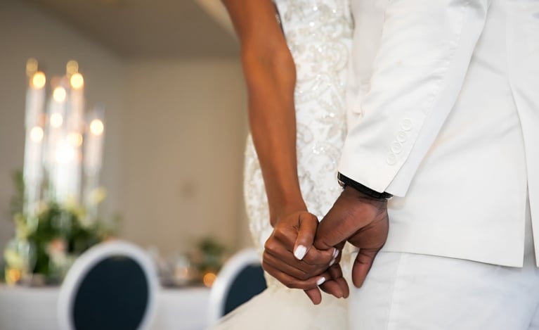 a bride and groom holding hands