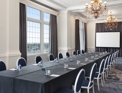 Room with a long table set up for meeting