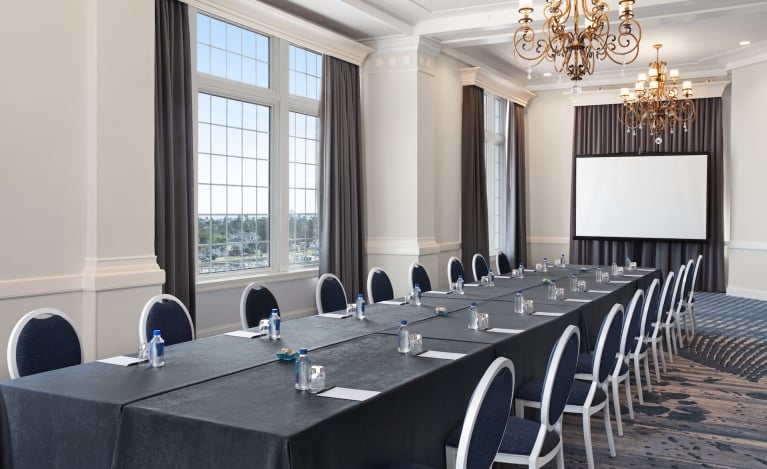 Room with a long table set up for meeting