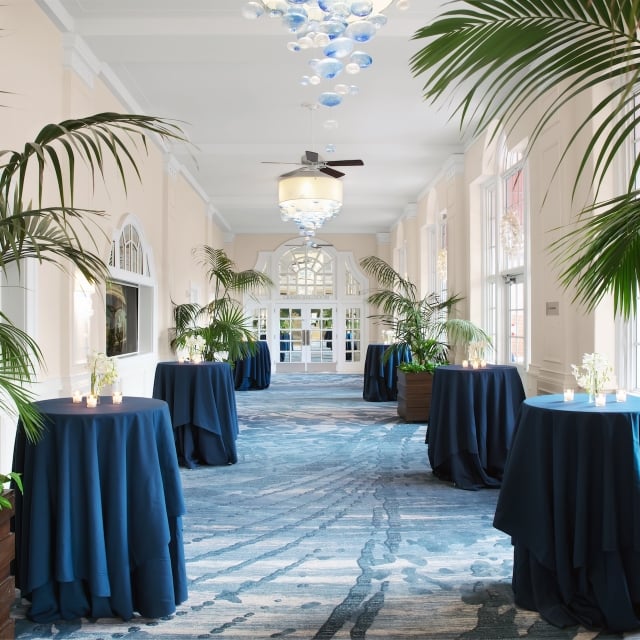 hallway with tall tables and plants