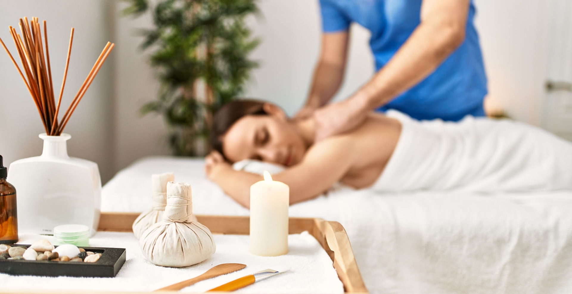 Young woman relaxed reciving back massage at beauty center.