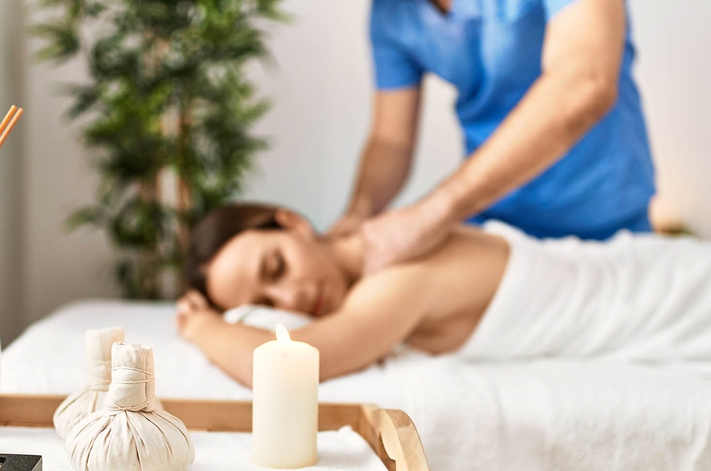 Young woman relaxed reciving back massage at beauty center.