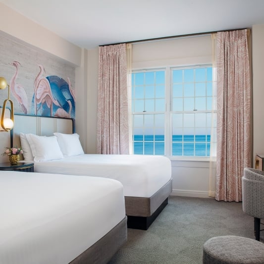 bedroom with two beds and view of the ocean