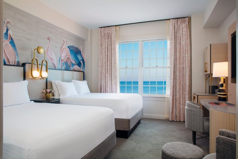 bedroom with two beds and view of the ocean