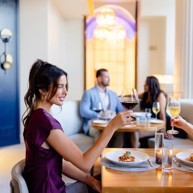 two women eating dinner and drinking wine