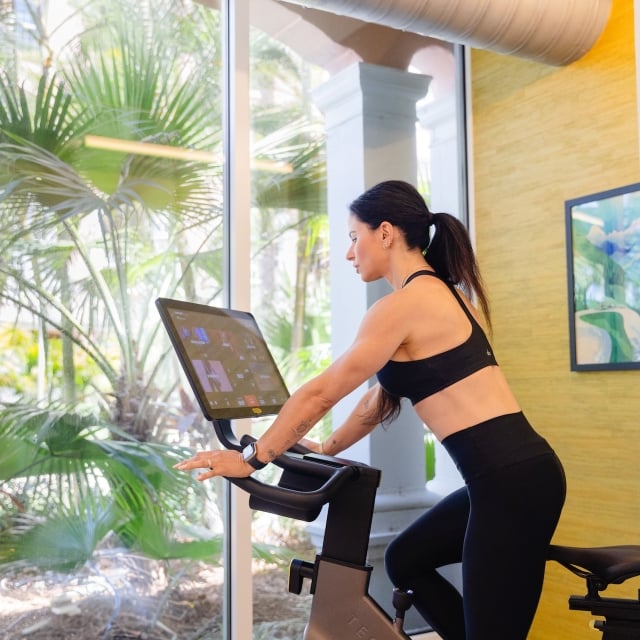 a woman using an exercise bike