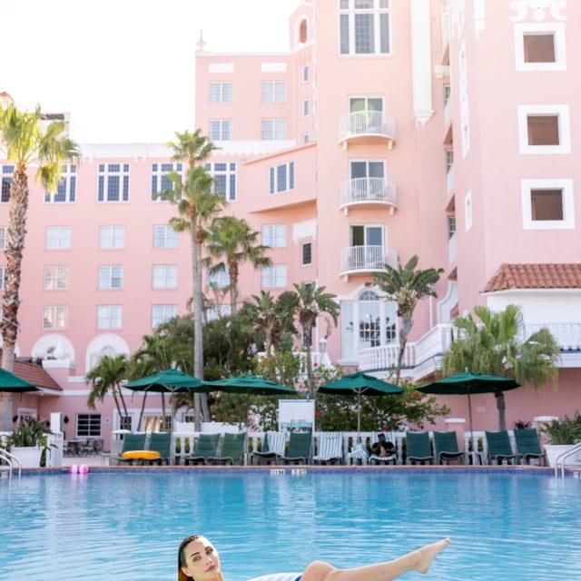 a woman lounging in an inflatable tube in the pool