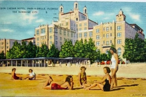 Old postcard with women sitting on the beach in front of the hotel