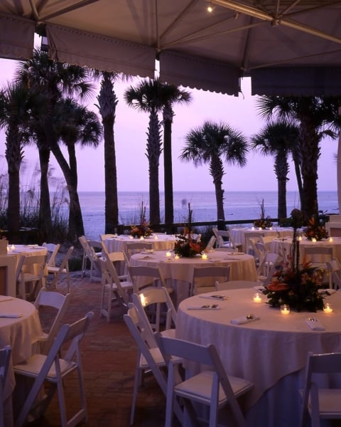 a pavilion on the beach set up for a wedding reception