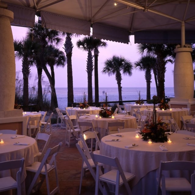 a pavilion on the beach set up for a wedding reception