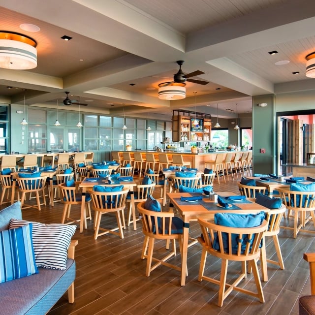 dining room at Rowe Bar with wood furniture and blue cushions