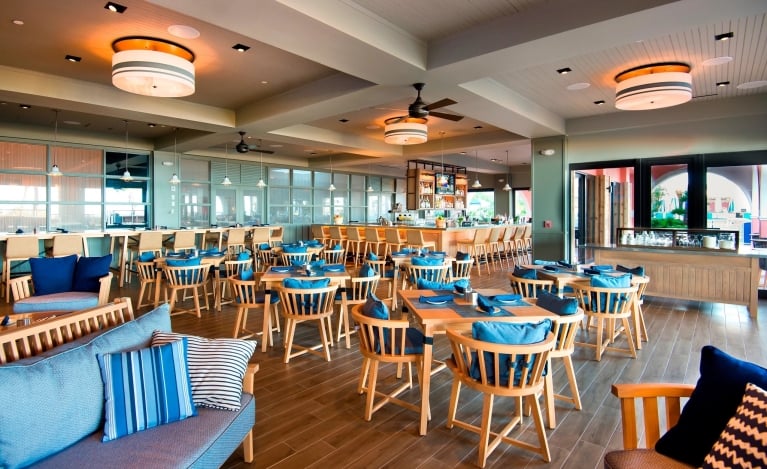 dining room at Rowe Bar with wood furniture and blue cushions