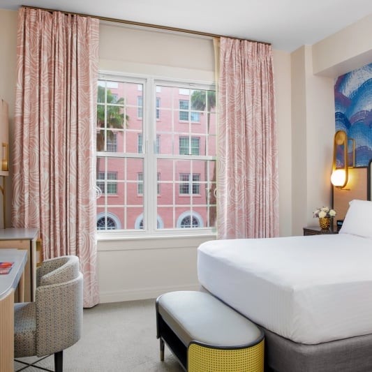 bedroom with small desk and view of the courtyard