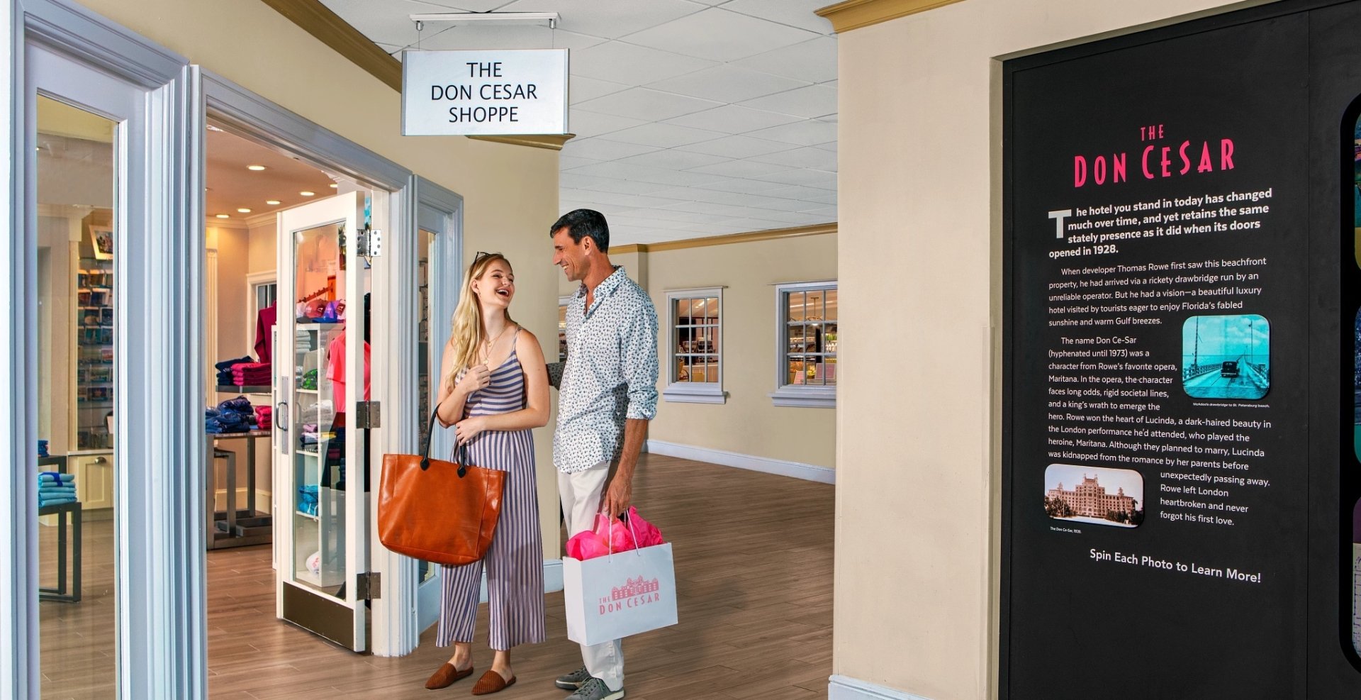 a couple about to walk into The Don CeSar Shoppe holding shopping bags