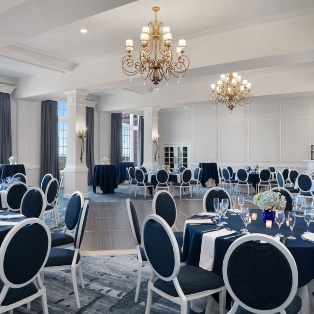 large room with a dance floor and round tables