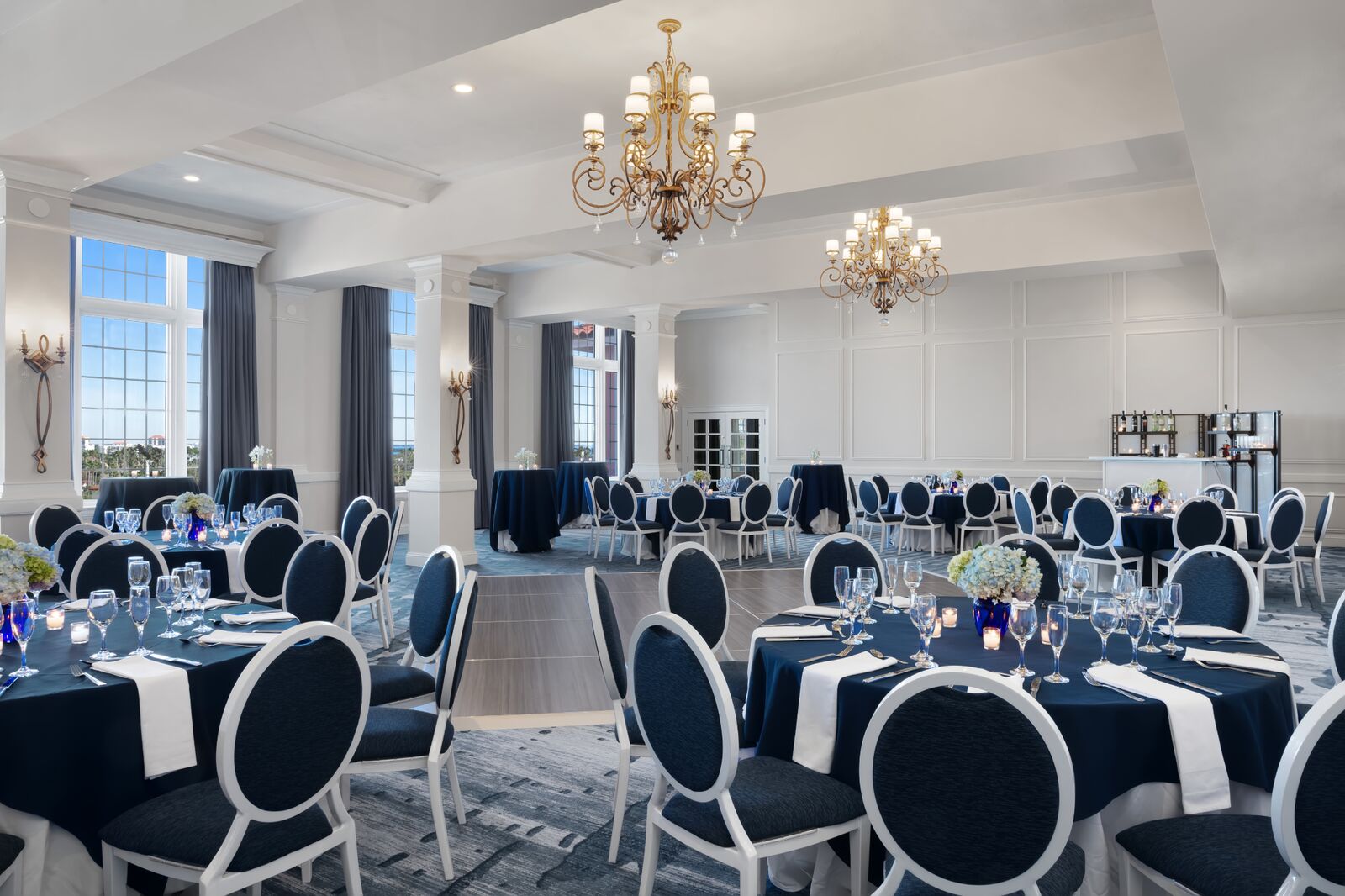 large room with a dance floor and round tables