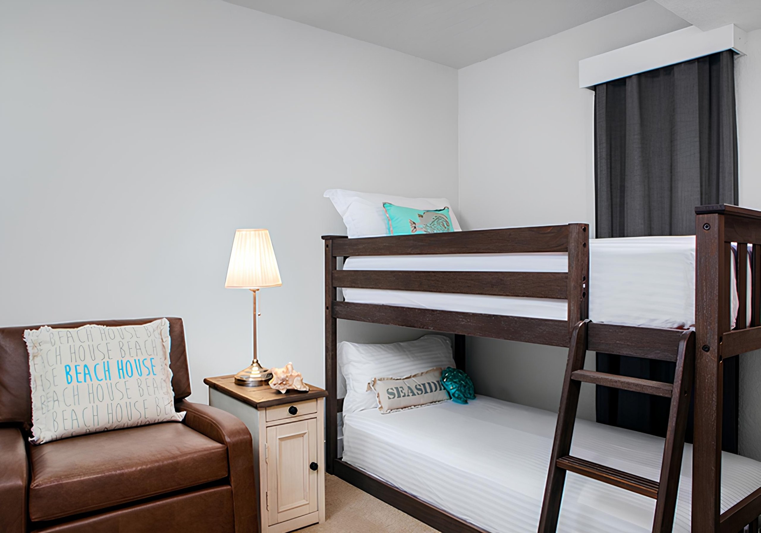 bedroom with small brown chair and bunkbeds