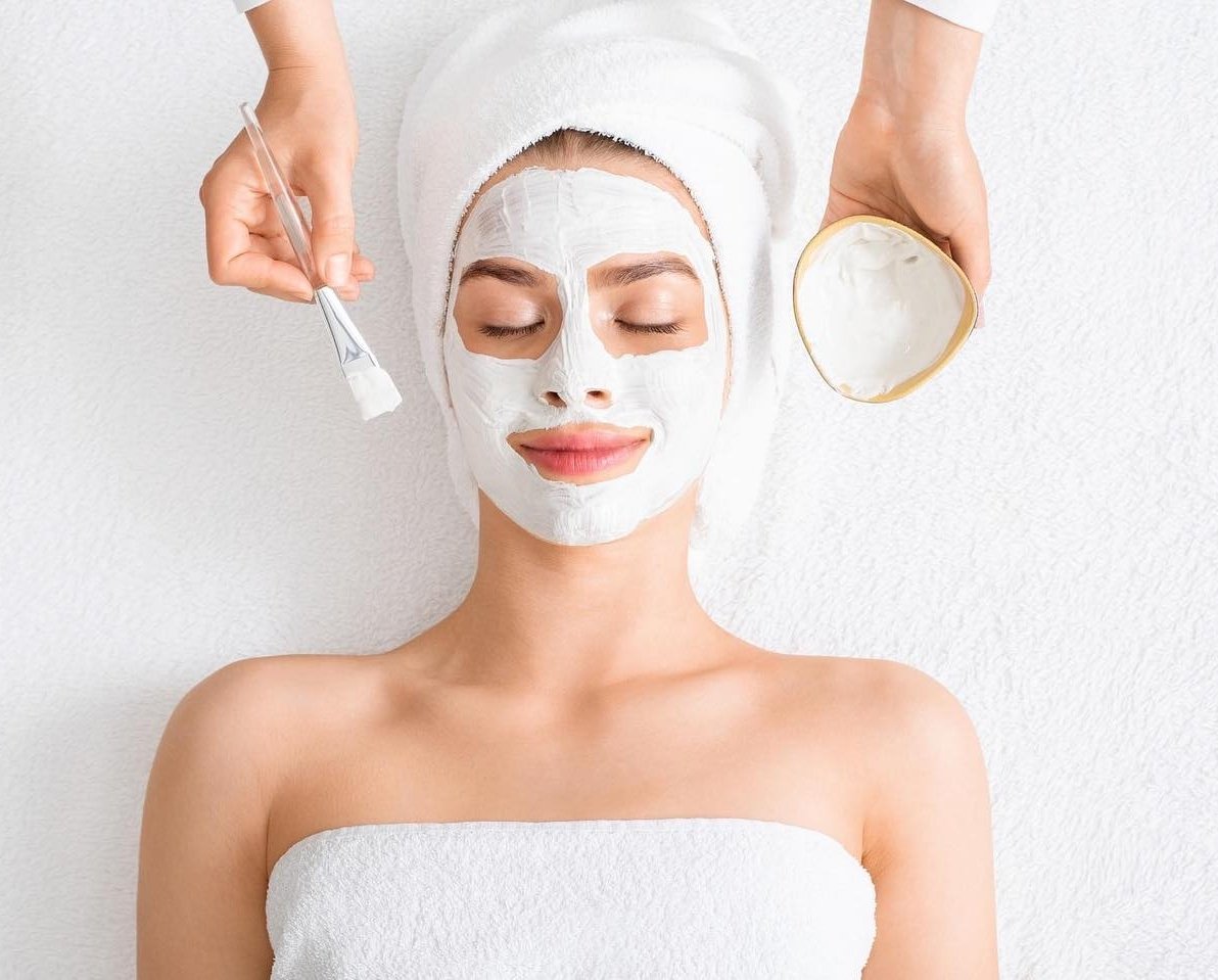 woman relaxes with a facial mask applied at a serene spa, enjoying a moment of self-care and rejuvenation.